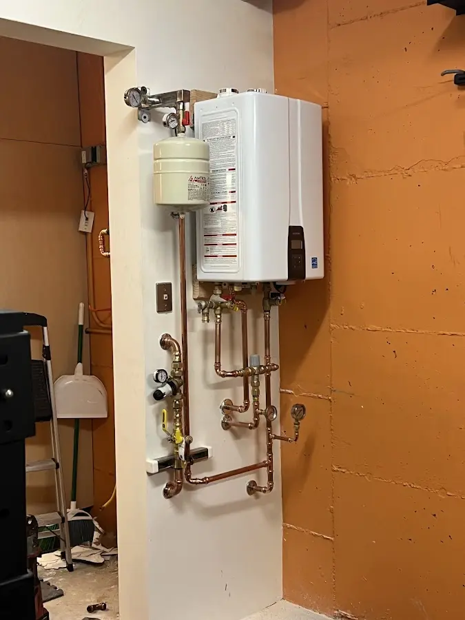Plumbing technician inspecting water heater connections in Orangeburg